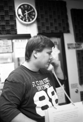 A man talks on the telephone, KVSC trivia weekend, St. Cloud State University
