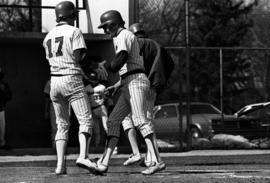 Bob Hegman greets Jim Eisenreich at home plate during a St. Cloud State University baseball game against Northern State University