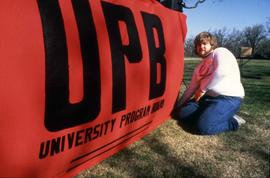 University Program Board (UPB) student with a sign, St. Cloud State University