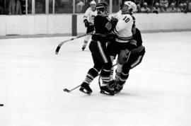 St. Cloud State hockey player Jeff Passolt gets hit during a game against St. Olaf