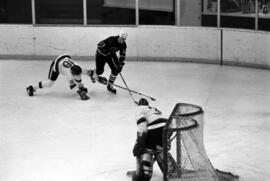 St. Cloud State hockey player Steve Martinson handles the puck during a game with St. John's University