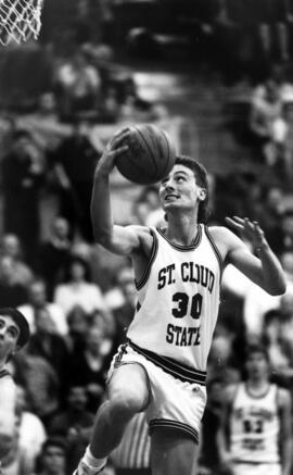 Basketball player Kevin Skarich runs to the basket during a game, St. Cloud State University