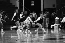 Dawn Anderson chases a basketball game during a game against the College of St. Catherine, St. Cloud State University