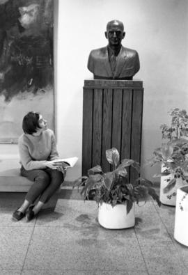 A woman gazes at the bust of Allen Atwood in Atwood Memorial Center (1966), St. Cloud State University