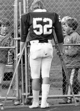 Injured football player Vic Christensen talks to children, St. Cloud State University