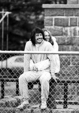 Man and woman sit together on bleachers, St. Cloud State University