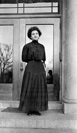 Pat Conley stands in front of Lawrence Hall (1905), St. Cloud State University