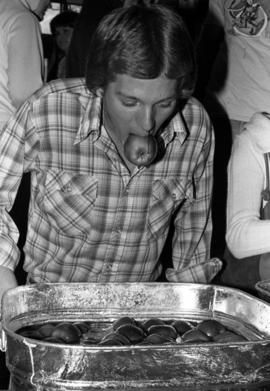 Man bops for apples at the Halloween Hullabaloo, St. Cloud State University