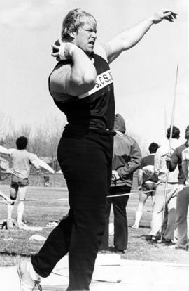 Layne Kelley prepares to throw a shot put, St. Cloud State University, April 17, 1982