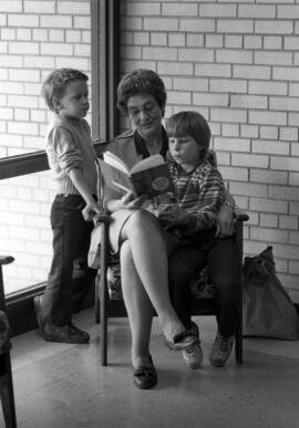 Woman reads a book to children, Gray Campus Laboratory School