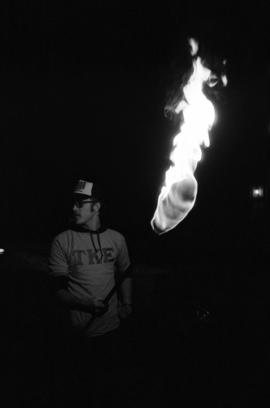 Student Barry Houchin carries a torch during the homecoming torchlight parade, St. Cloud State University