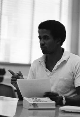 Ken Lewis holds a document at a Mass Communications workshop, St. Cloud State University